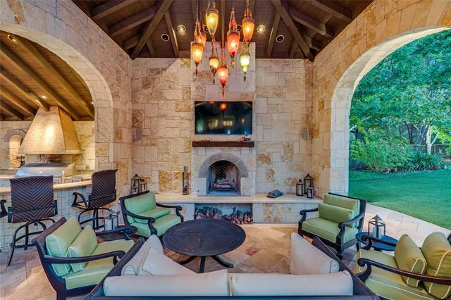 a view of a patio with a table and chairs under an umbrella