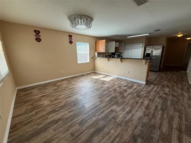 a view of a kitchen with a sink and dishwasher wooden floor