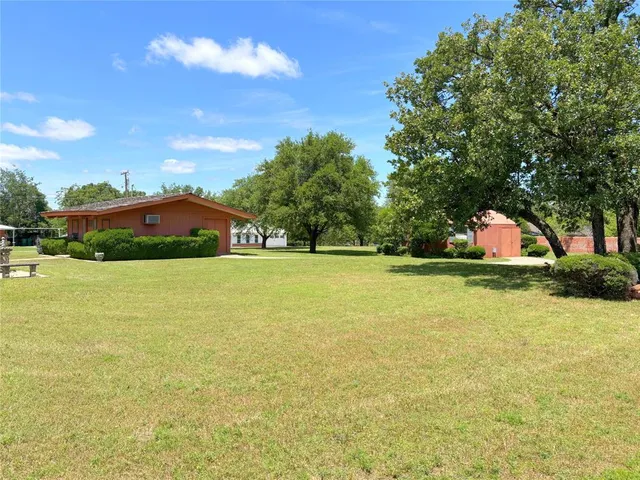 a view of swimming pool and trees in the background
