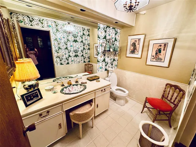 a bathroom with a sink mirror vanity and toilet