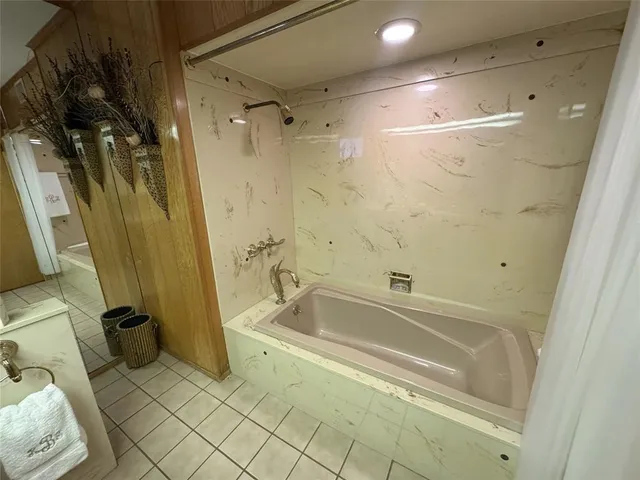 a bathroom with a bathtub and a shower