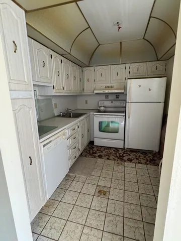 a kitchen with cabinets and window