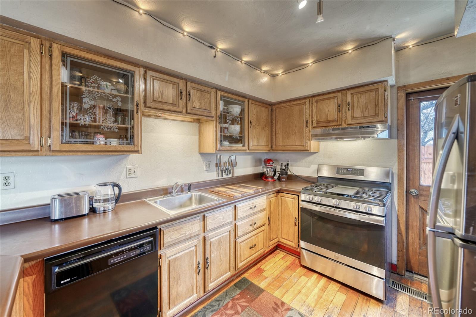 1335 F Street Salida, CO 81201 - Photo 12 of 44 a kitchen with stainless steel appliances granite countertop a stove and cabinets