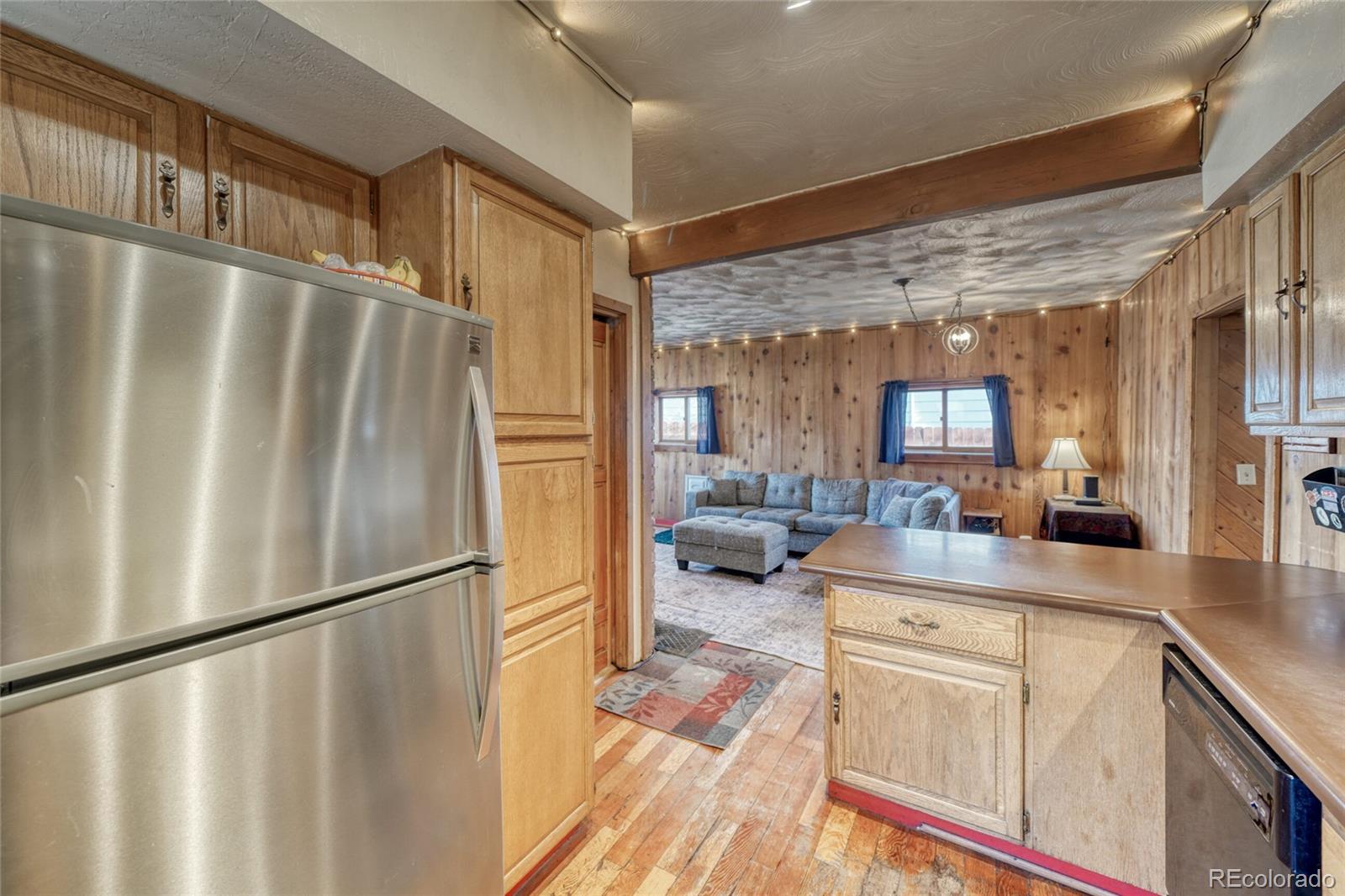 1335 F Street Salida, CO 81201 - Photo 14 of 44 a kitchen with stainless steel appliances a refrigerator a sink a stove and cabinets