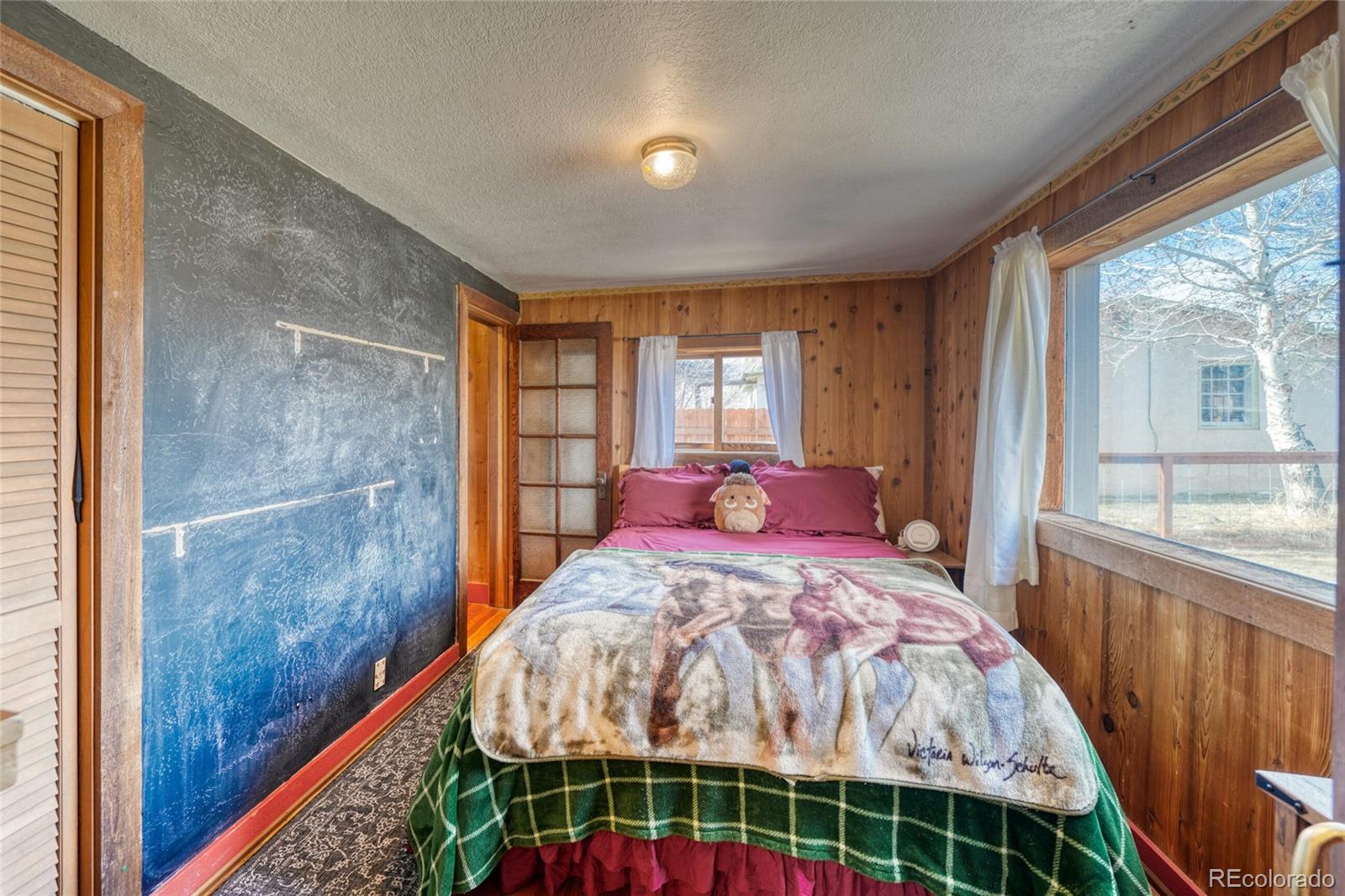 1335 F Street Salida, CO 81201 - Photo 15 of 44 a bed sitting in a bedroom next to a window