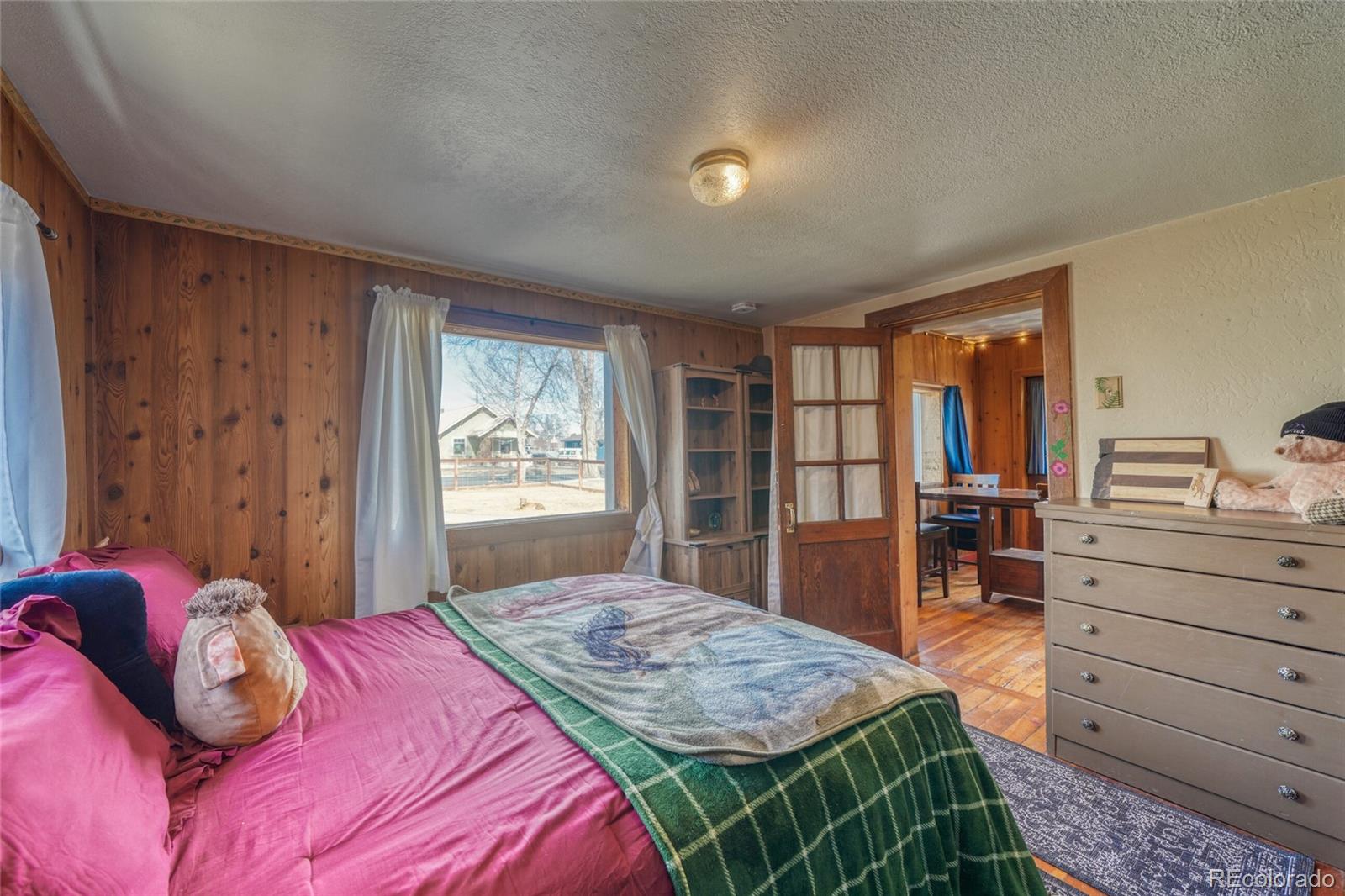 1335 F Street Salida, CO 81201 - Photo 16 of 44 a bedroom with a bed and a dresser