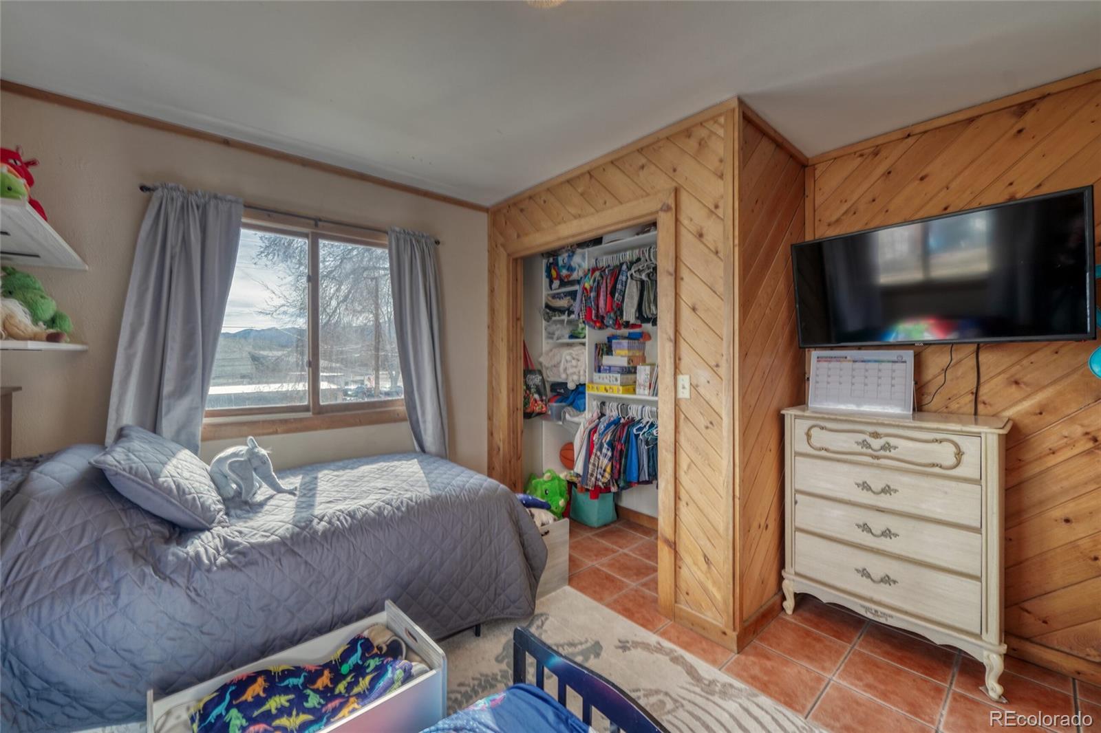 1335 F Street Salida, CO 81201 - Photo 21 of 44 a bedroom with a bed and a flat screen tv
