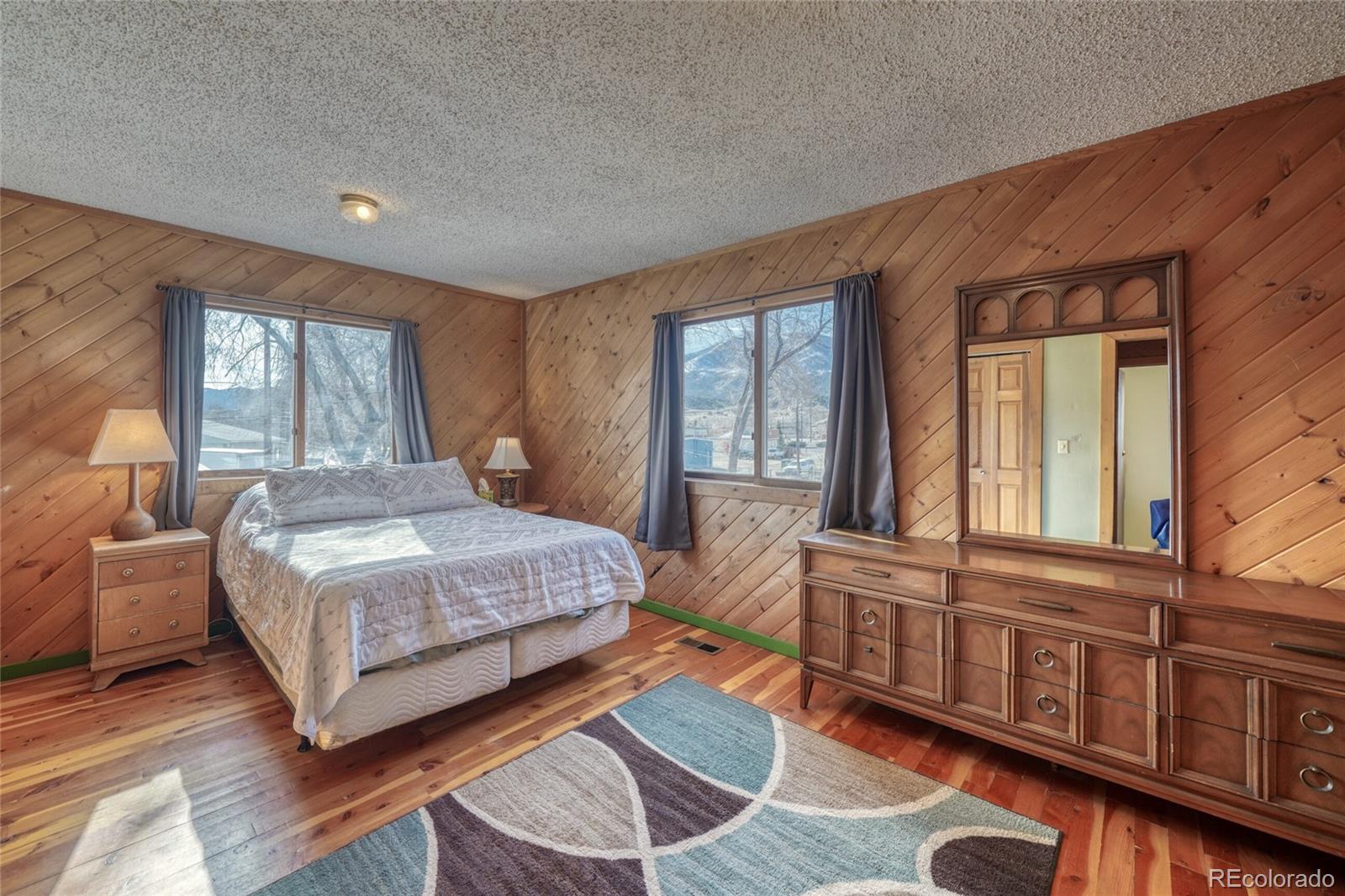1335 F Street Salida, CO 81201 - Photo 23 of 44 a bedroom with a large bed and windows