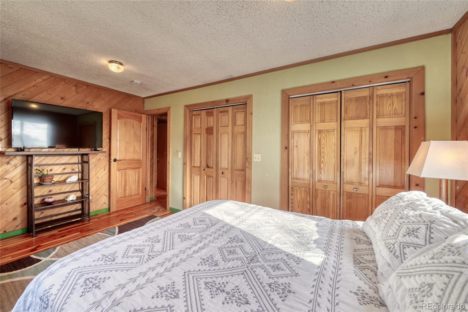 1335 F Street Salida, CO 81201 - Photo 24 of 44 a bedroom with a bed and a flat screen tv