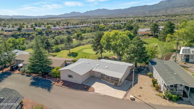 an aerial view of a house with a yard and lake view