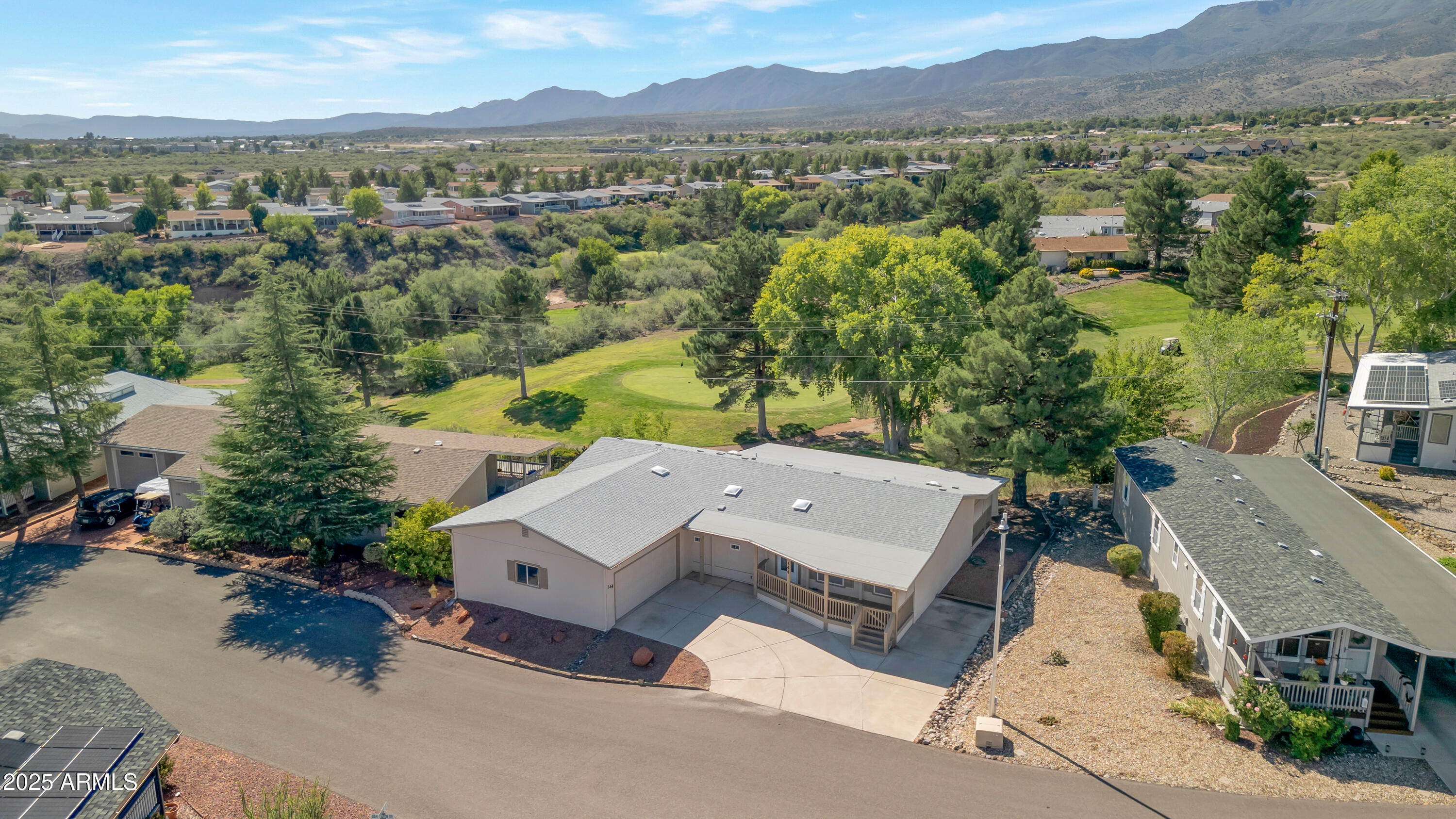 an aerial view of a house with a yard and lake view