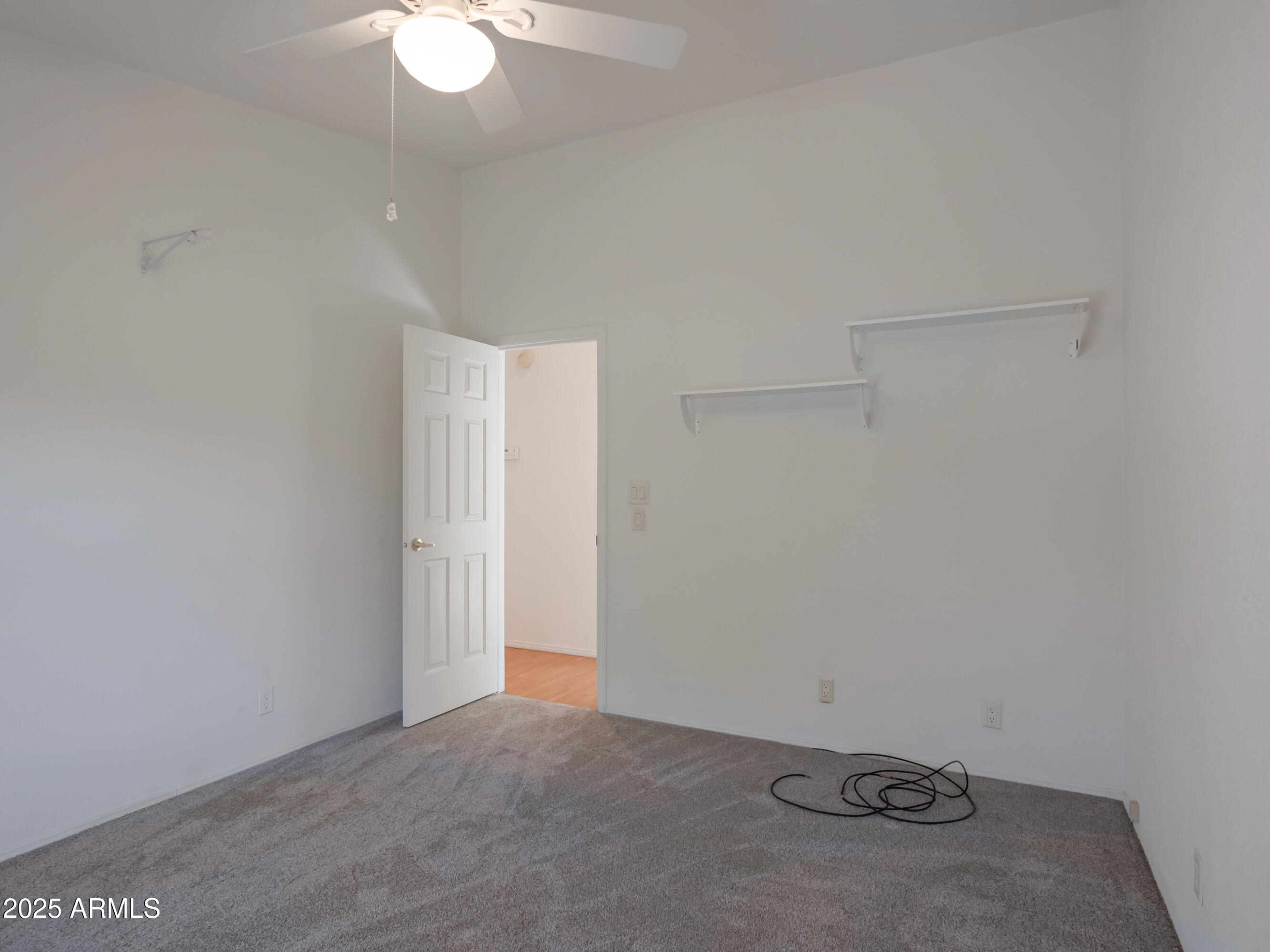 2050 West State Rte 89A, Unit 344 Sedona, AZ 86336 - Photo 15 of 35 an empty room with a ceiling fan and carpet