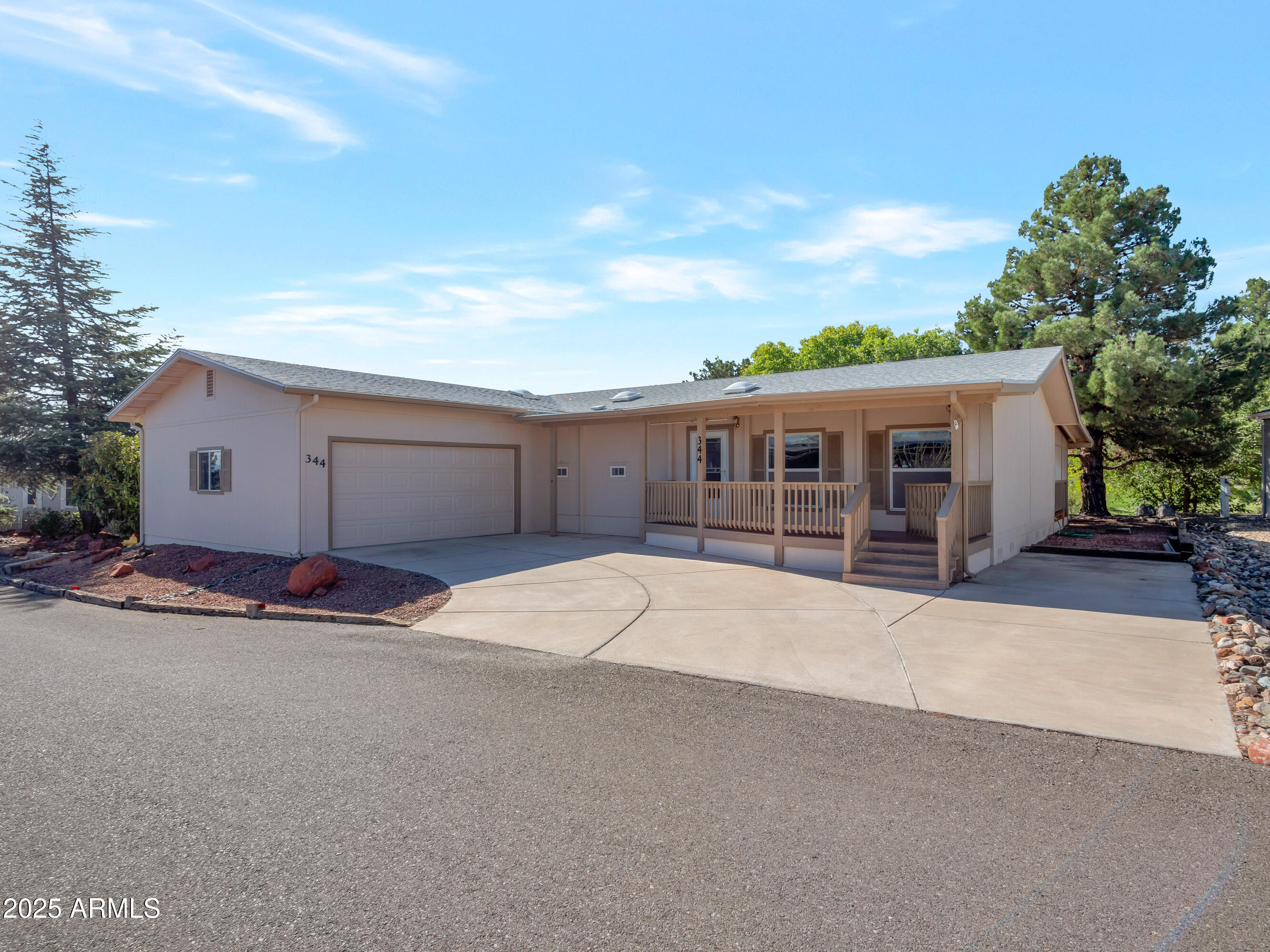 2050 West State Rte 89A, Unit 344 Sedona, AZ 86336 - Photo 2 of 35 a front view of a house with a yard and garage
