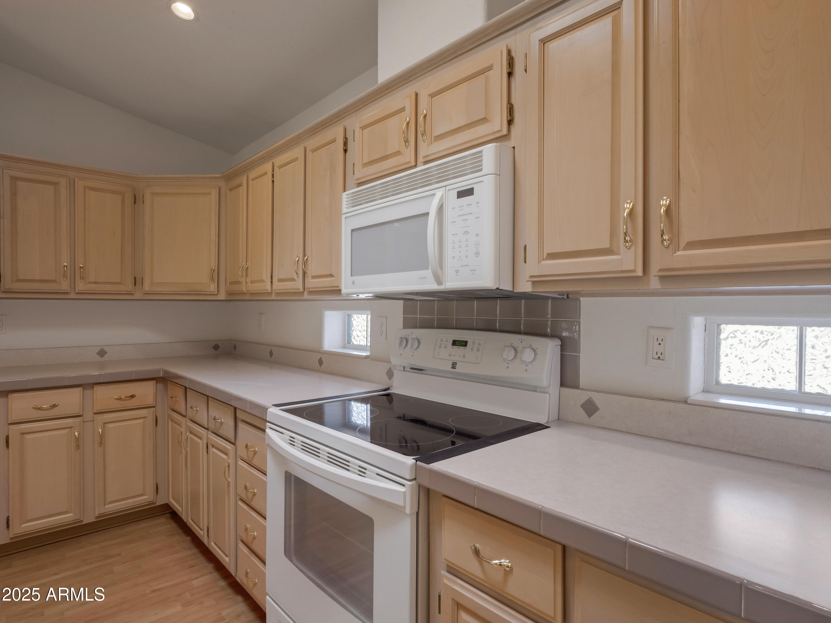 2050 West State Rte 89A, Unit 344 Sedona, AZ 86336 - Photo 21 of 35 a kitchen with white cabinets and white appliances