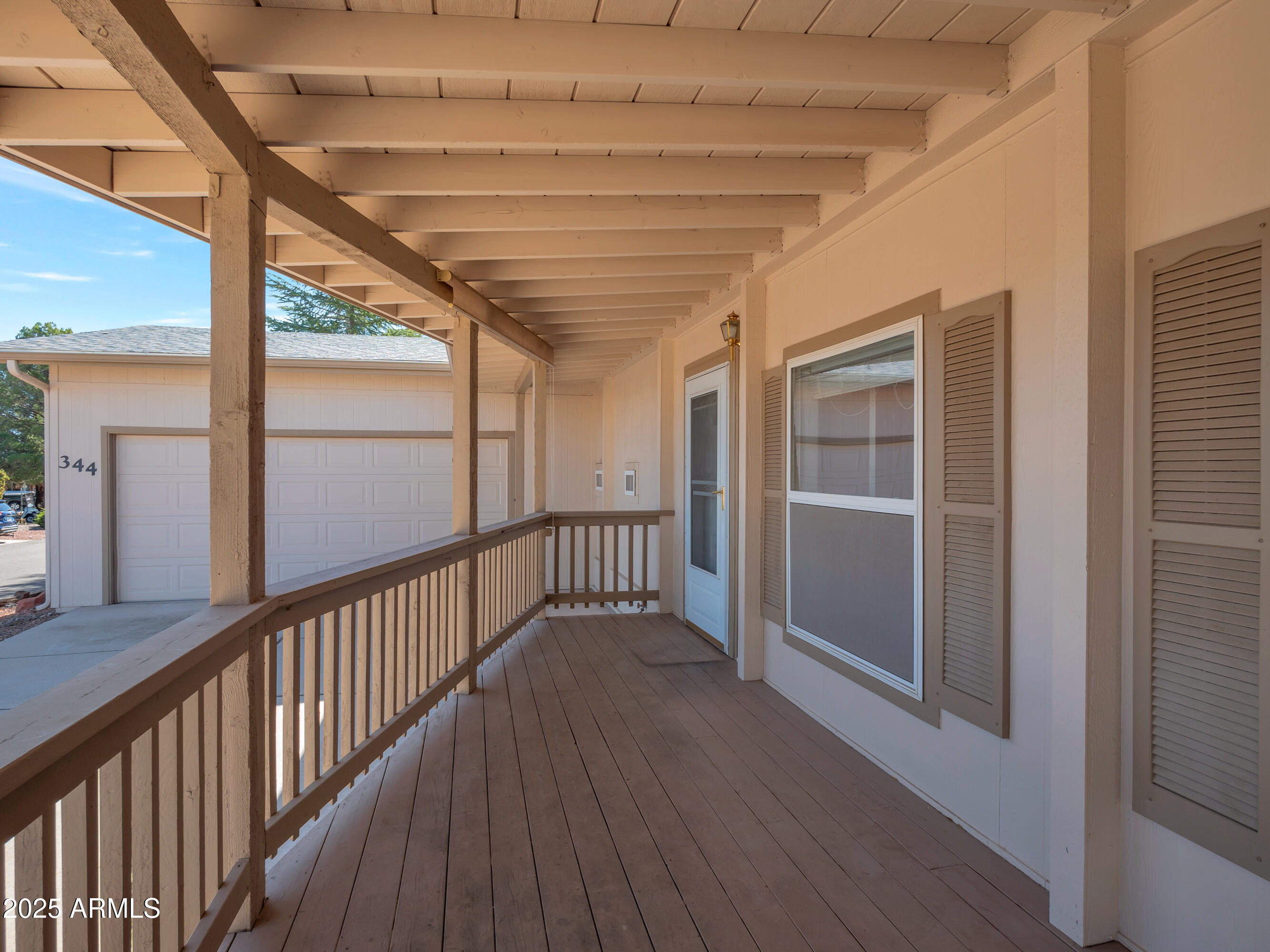 2050 West State Rte 89A, Unit 344 Sedona, AZ 86336 - Photo 3 of 35 a view of a porch with wooden floor and windows