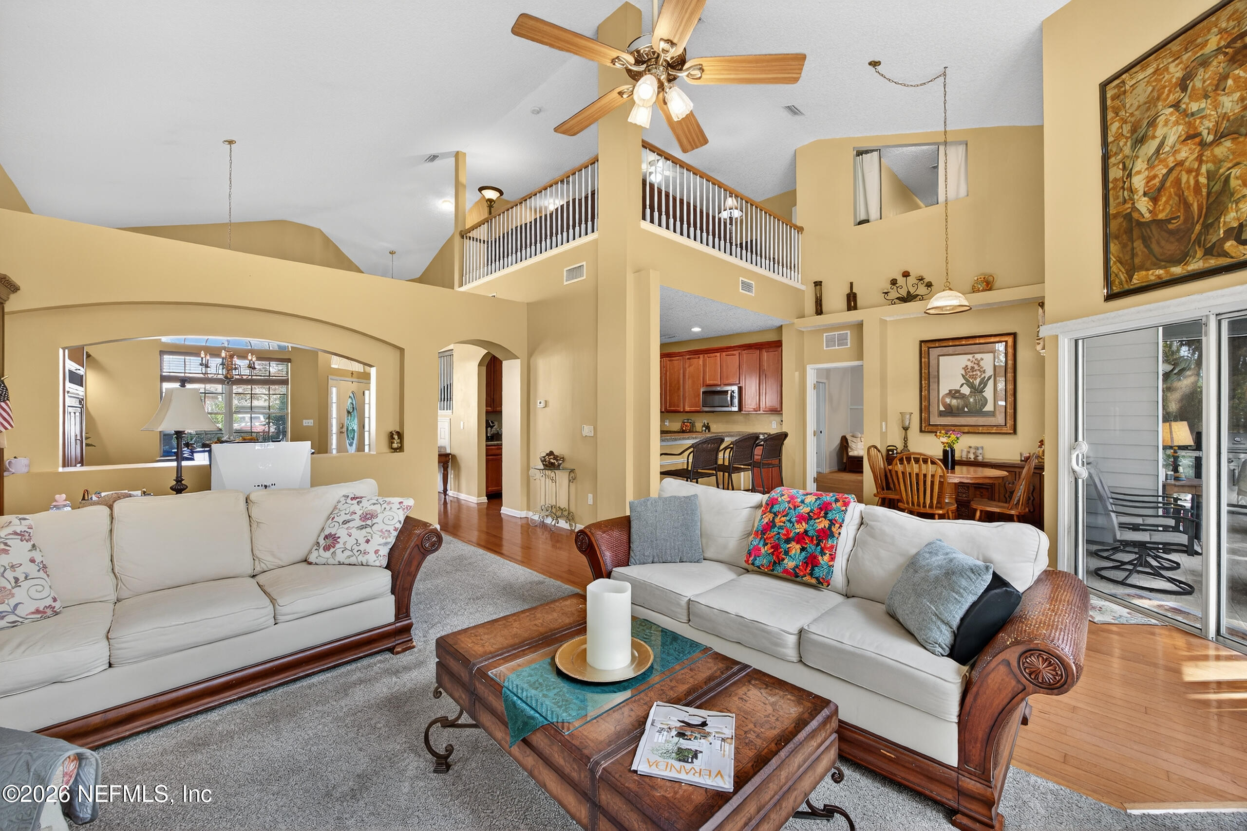 588 Reflection Cove Road Jacksonville, FL 32218 - Photo 11 of 53 a living room with furniture kitchen view and a chandelier