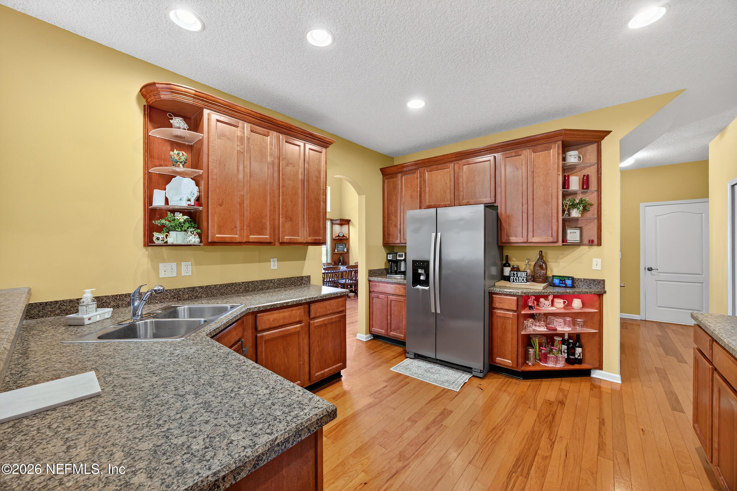 588 Reflection Cove Road Jacksonville, FL 32218 - Photo 15 of 53 a kitchen with stainless steel appliances granite countertop a refrigerator stove top oven and sink