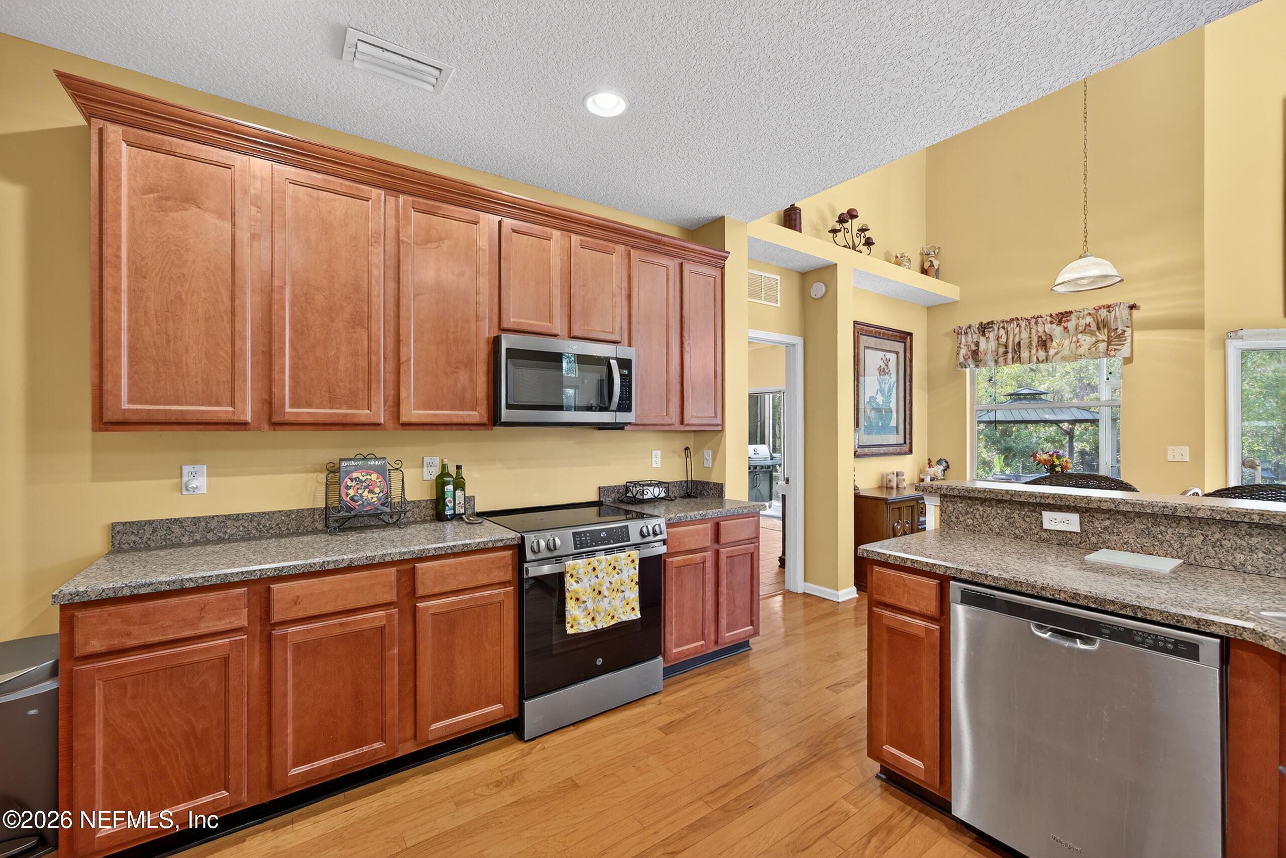 588 Reflection Cove Road Jacksonville, FL 32218 - Photo 17 of 53 a kitchen with stainless steel appliances granite countertop a sink stove and refrigerator