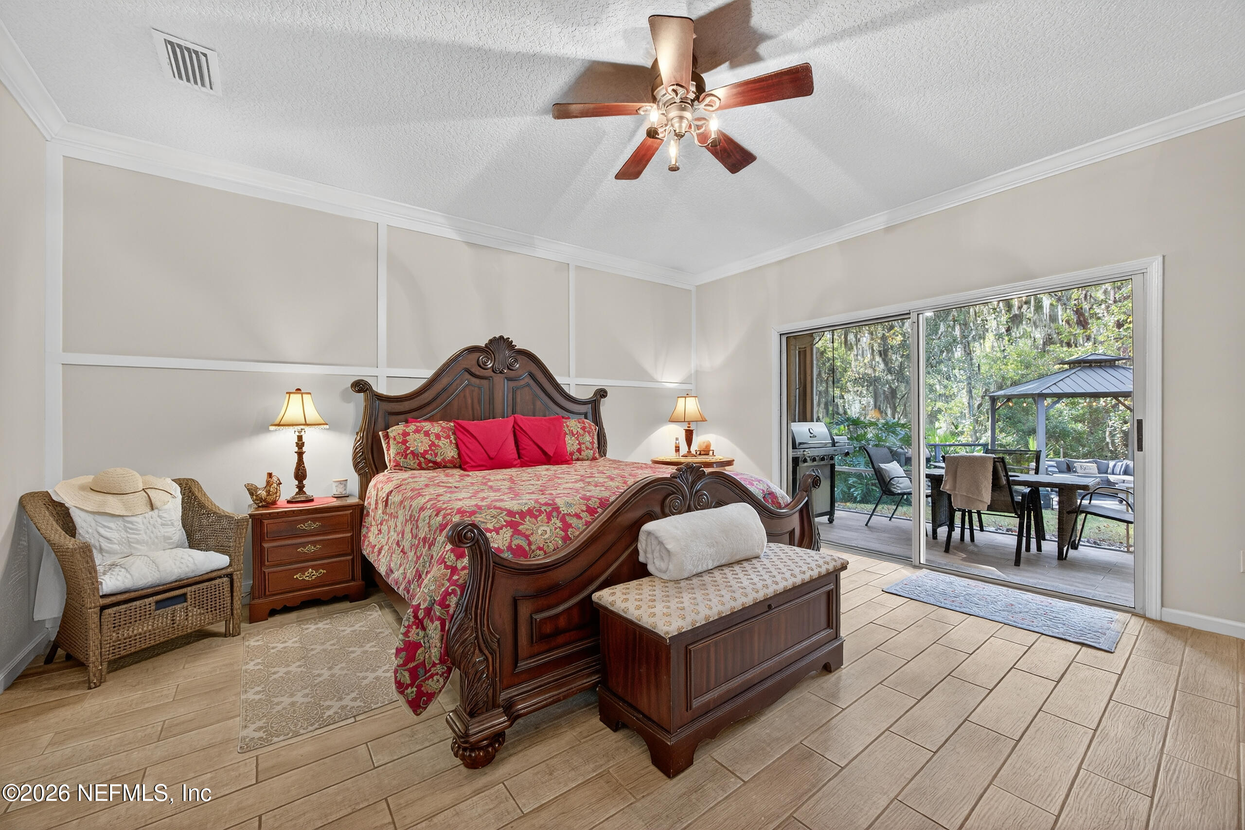 588 Reflection Cove Road Jacksonville, FL 32218 - Photo 21 of 53 a bedroom with a bed a lamp and a large window with the outer view