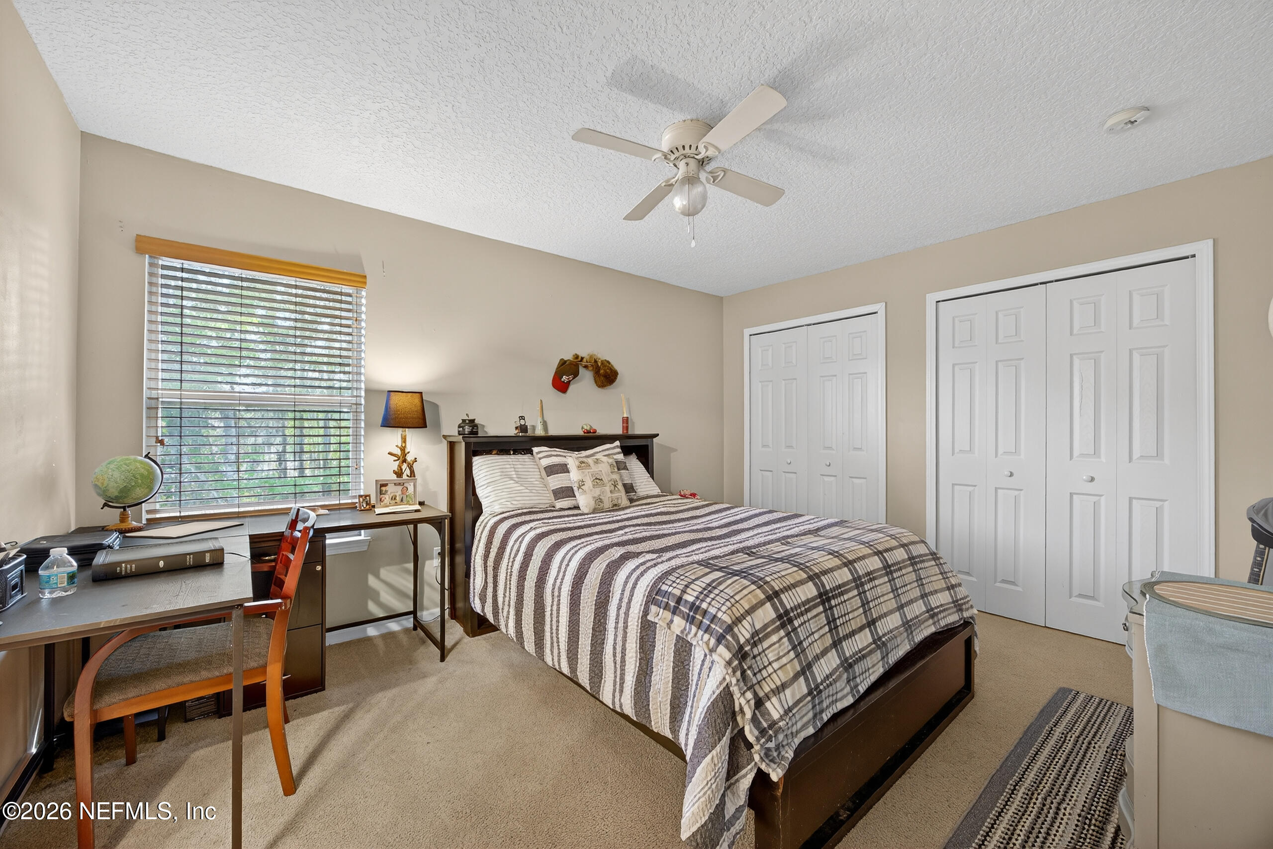 588 Reflection Cove Road Jacksonville, FL 32218 - Photo 30 of 53 a bedroom with a bed and a chandelier