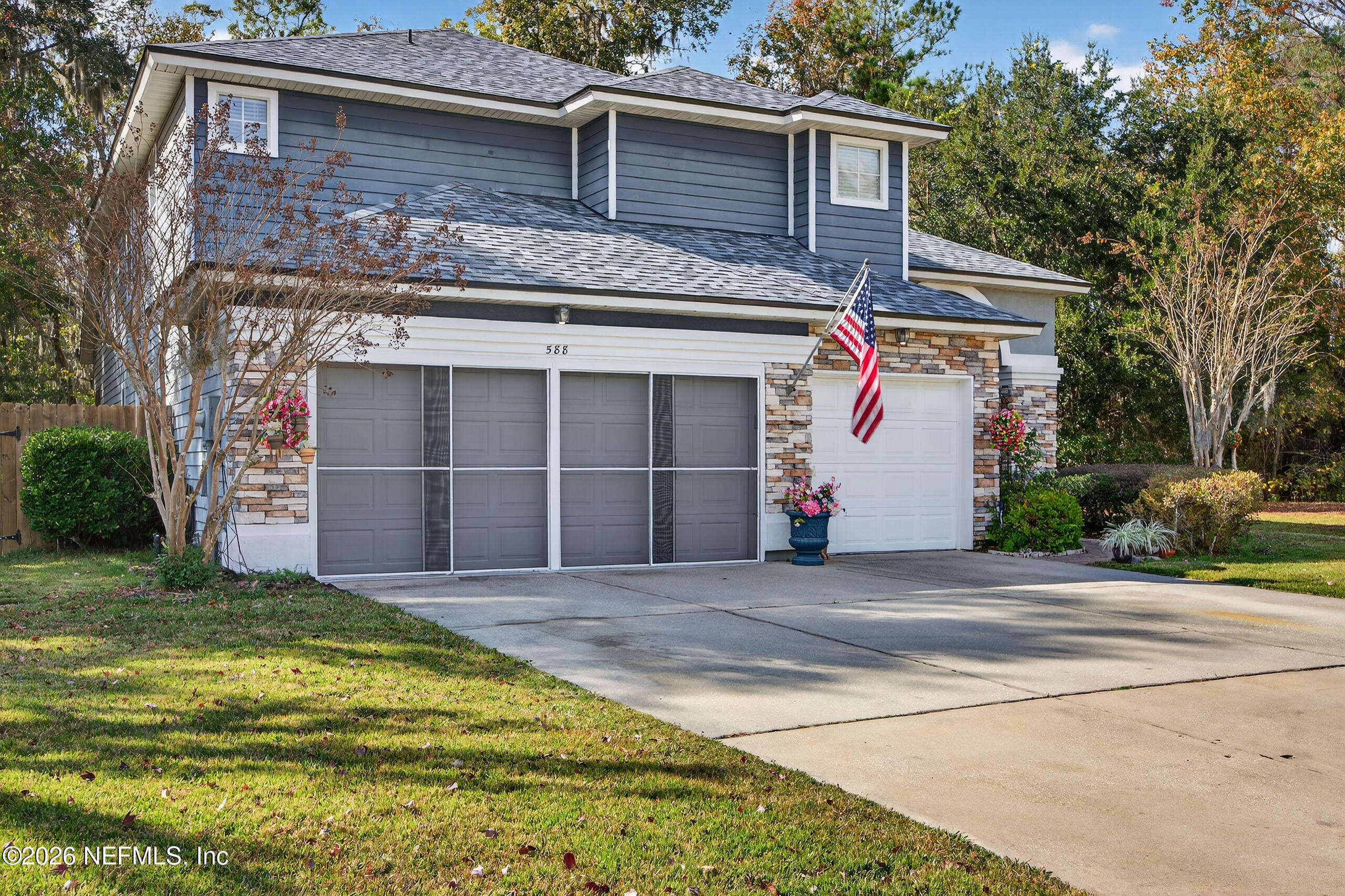 588 Reflection Cove Road Jacksonville, FL 32218 - Photo 3 of 53 a front view of a house with a yard and garage