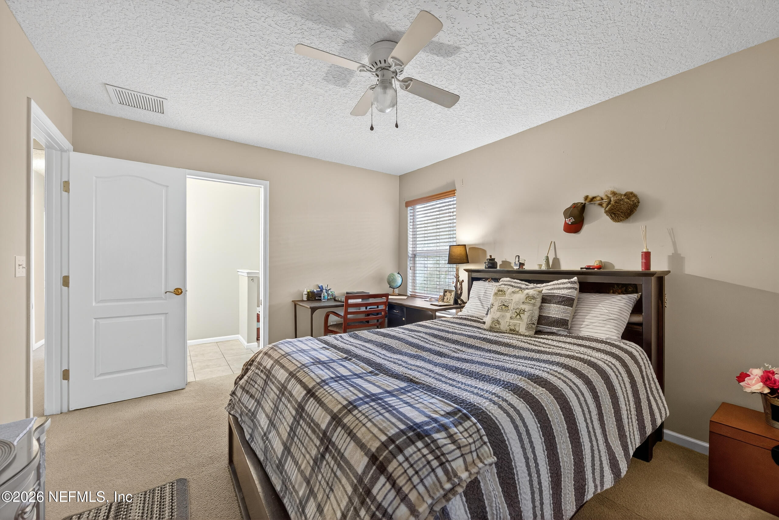 588 Reflection Cove Road Jacksonville, FL 32218 - Photo 31 of 53 a bedroom with a bed and a chandelier