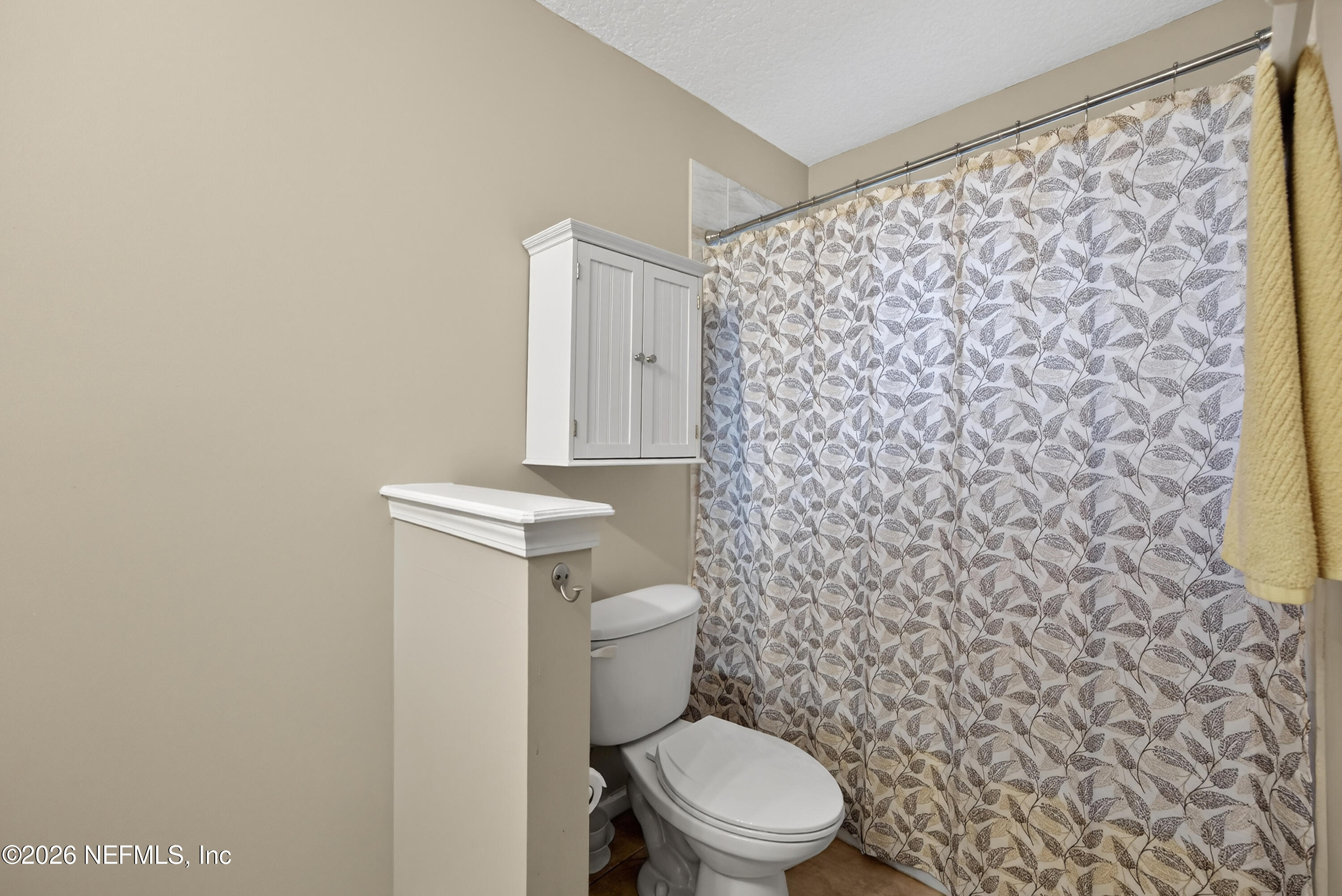 588 Reflection Cove Road Jacksonville, FL 32218 - Photo 33 of 53 a white toilet sitting next to a shower curtain