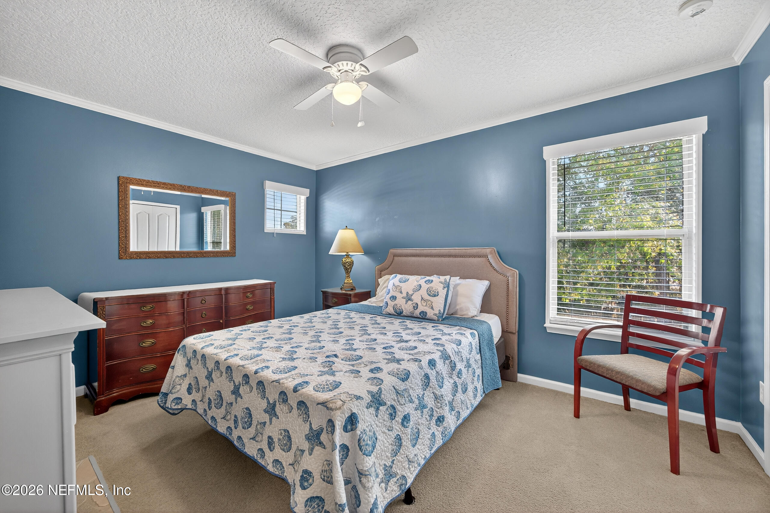 588 Reflection Cove Road Jacksonville, FL 32218 - Photo 34 of 53 a bedroom with a bed and a chandelier