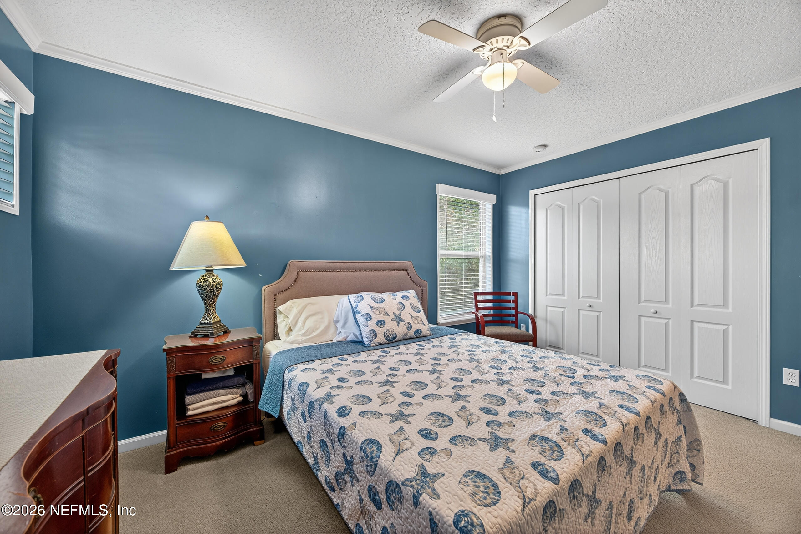 588 Reflection Cove Road Jacksonville, FL 32218 - Photo 35 of 53 a bedroom with a bed and a chandelier