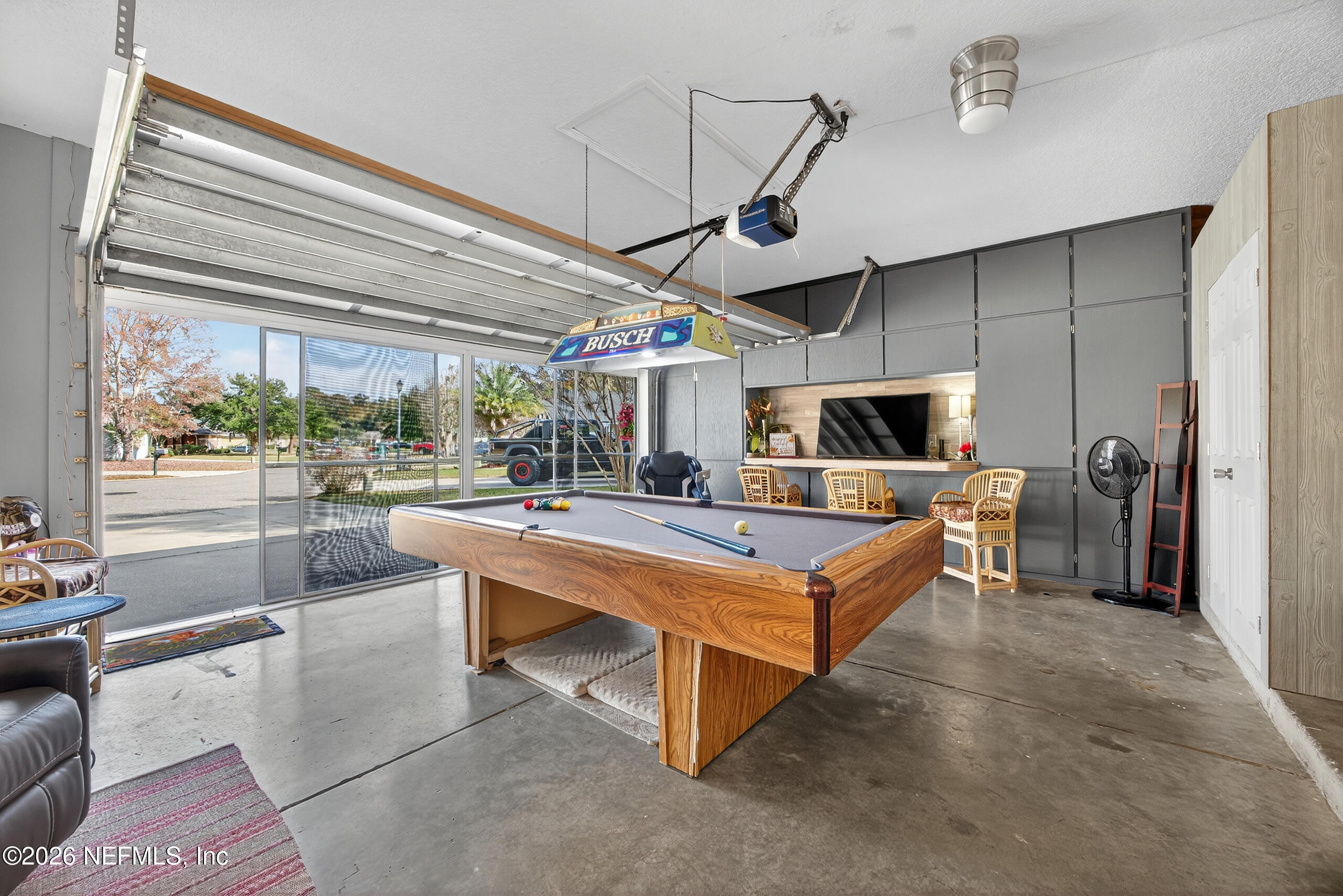588 Reflection Cove Road Jacksonville, FL 32218 - Photo 43 of 53 a living room with a table tennis table and chairs