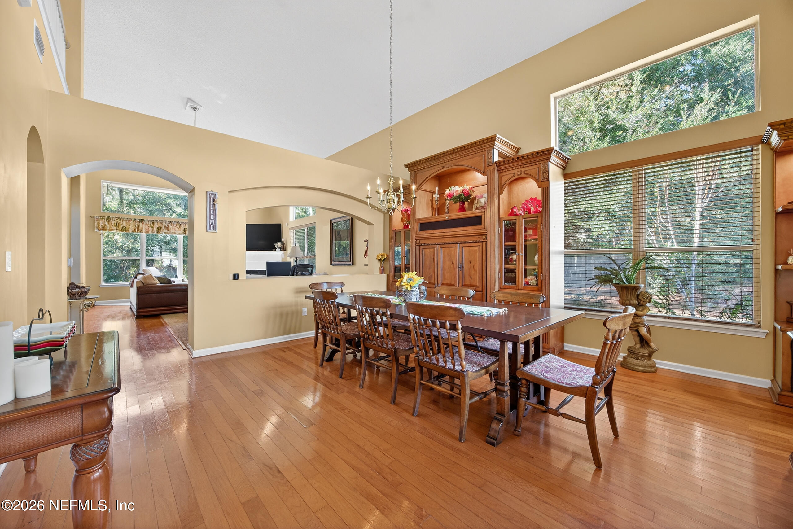 588 Reflection Cove Road Jacksonville, FL 32218 - Photo 5 of 53 a dining room with wooden floor a glass table and chairs