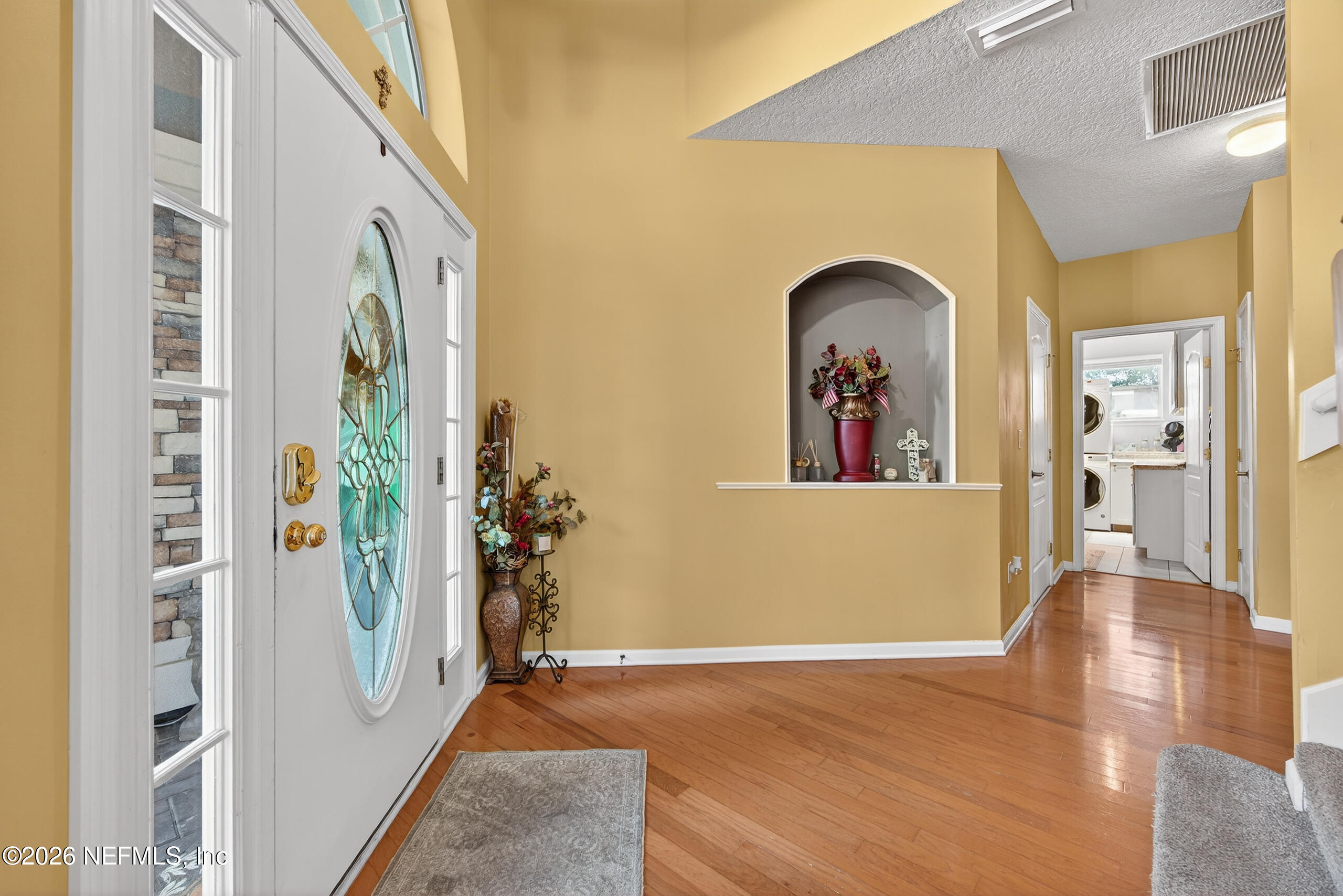 588 Reflection Cove Road Jacksonville, FL 32218 - Photo 7 of 53 a view of a hallway with wooden floor and windows