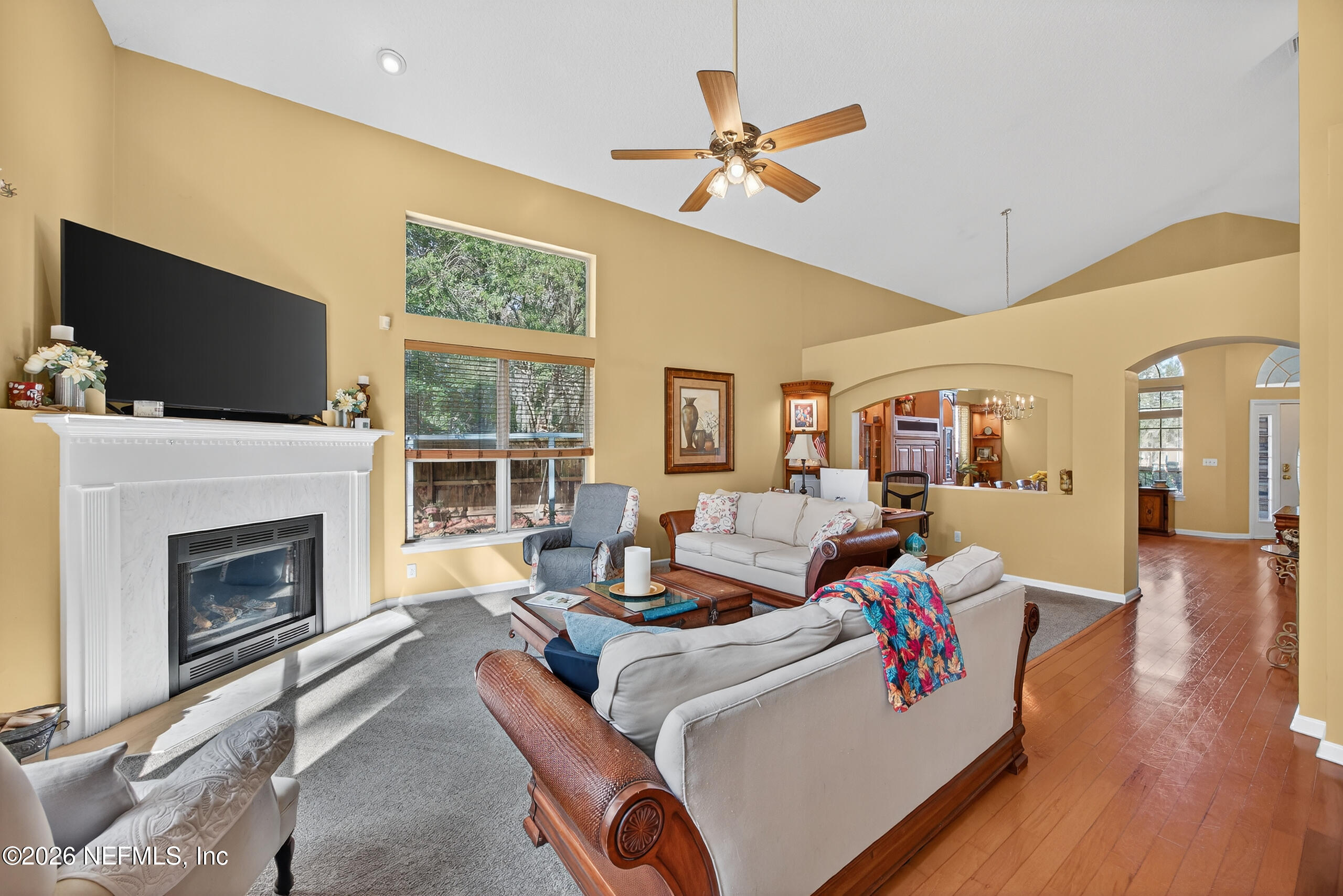 588 Reflection Cove Road Jacksonville, FL 32218 - Photo 10 of 53 a living room with furniture a flat screen tv and a fireplace