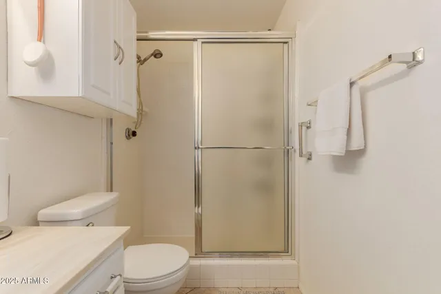 a white toilet sitting next to a bathroom sink