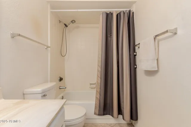 a bathroom with a toilet a sink and shower