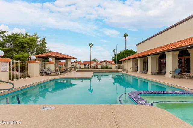 a view of a swimming pool with a lounge chairs