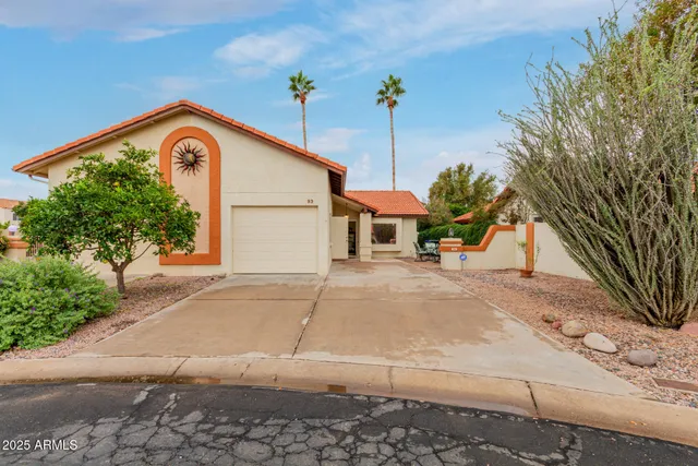 a view of a house with a yard and garage