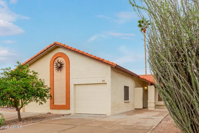 a view of a house with a backyard and a tree