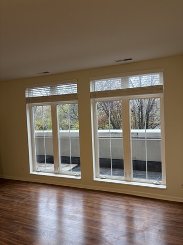 625 Deerfield Road, Unit 209 Deerfield, IL 60015 - Photo 8 of 12 a view of wooden floor and windows in a room