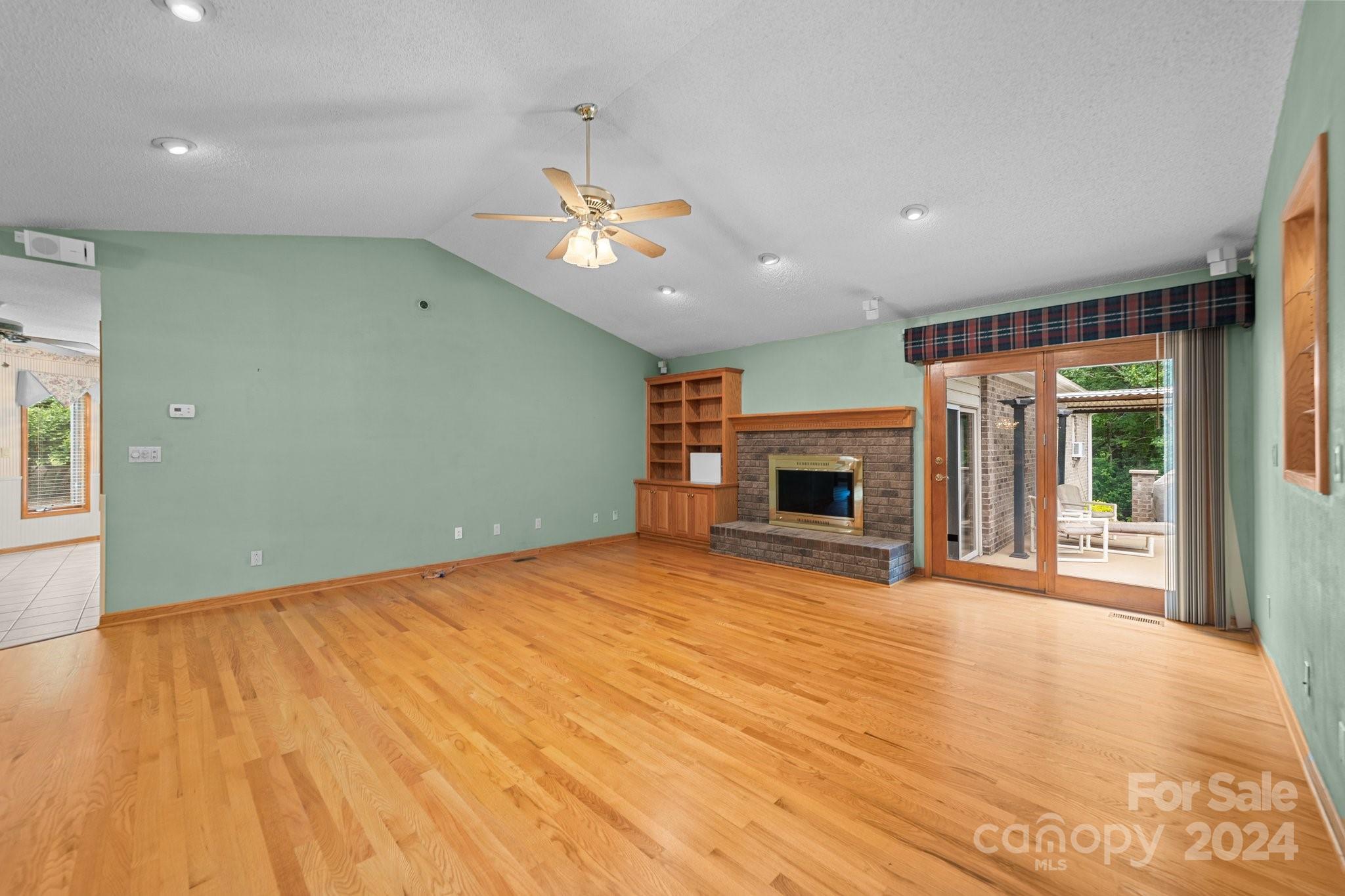 1808 Thompson Drive Concord, NC 28025 - Photo 12 of 48 a view of empty room with wooden floor and fireplace