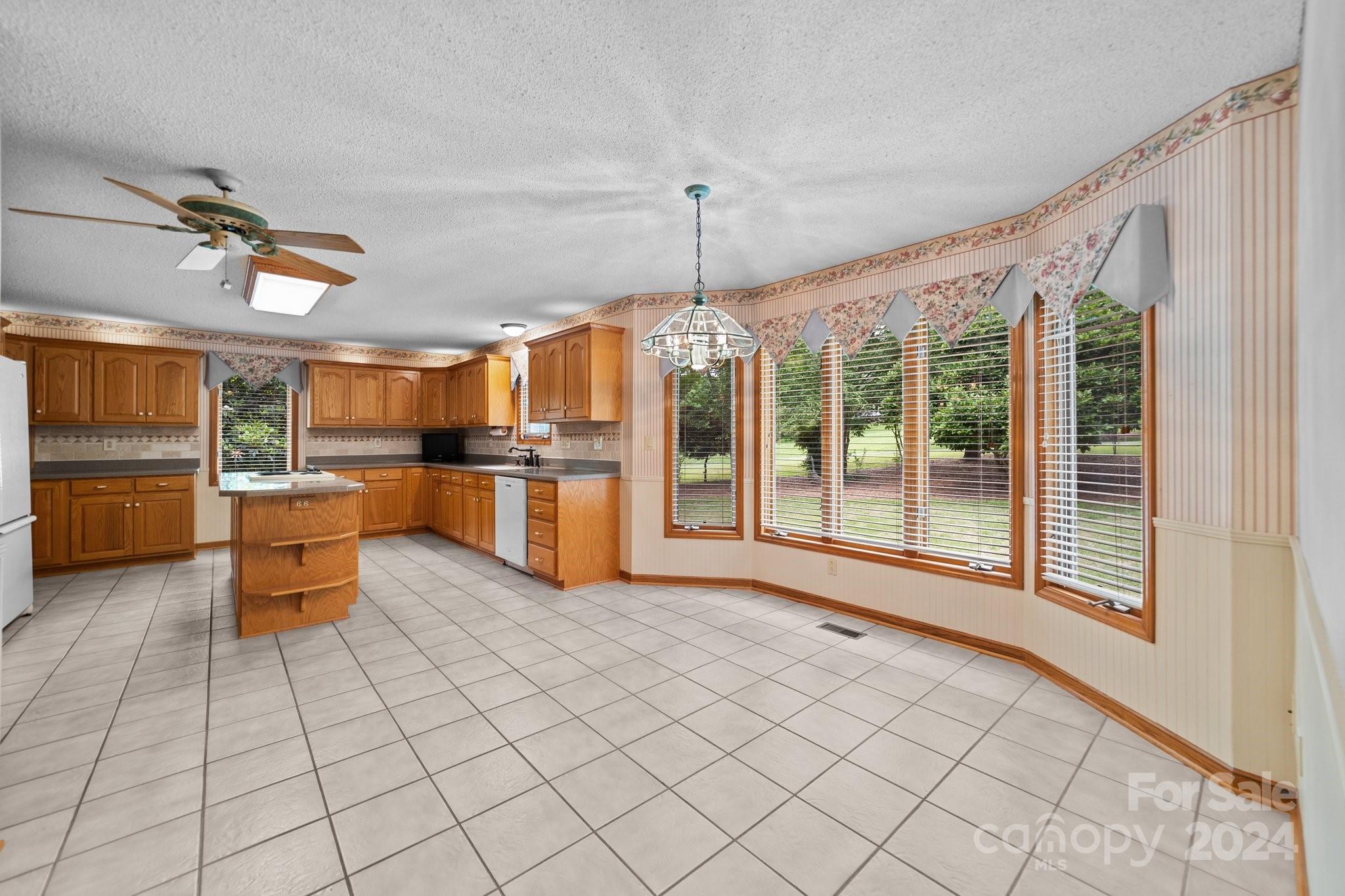 1808 Thompson Drive Concord, NC 28025 - Photo 17 of 48 a open kitchen with stainless steel appliances granite countertop a refrigerator and a stove top oven