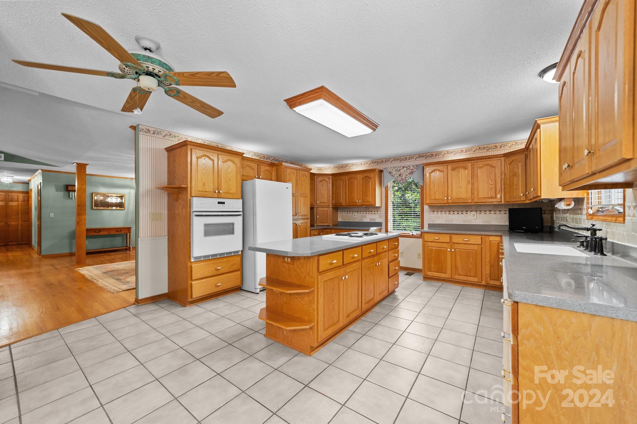 1808 Thompson Drive Concord, NC 28025 - Photo 19 of 48 a kitchen with stainless steel appliances granite countertop a refrigerator and a stove top oven