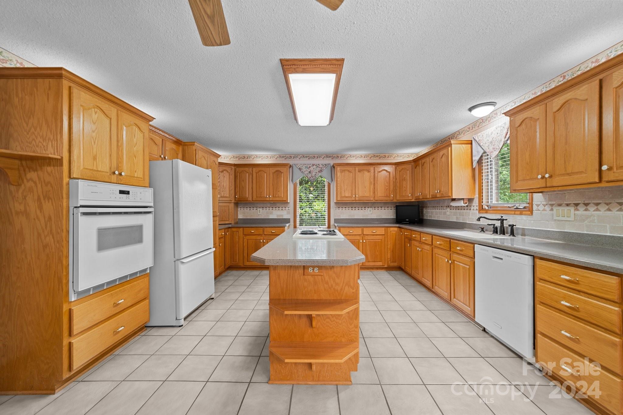 1808 Thompson Drive Concord, NC 28025 - Photo 20 of 48 a kitchen with stainless steel appliances granite countertop a stove a sink and a refrigerator