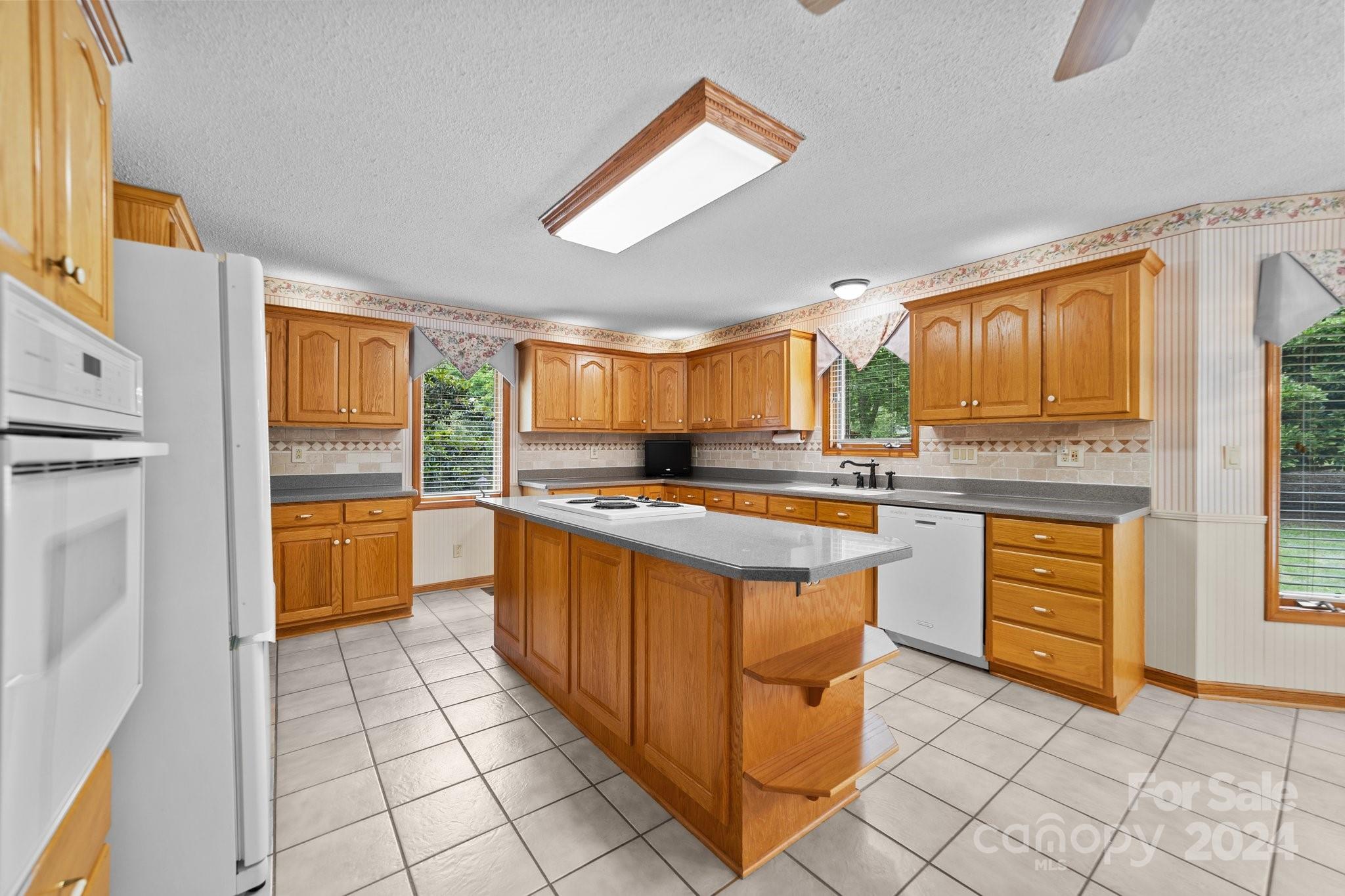 1808 Thompson Drive Concord, NC 28025 - Photo 21 of 48 a kitchen with stainless steel appliances granite countertop a stove a sink and a refrigerator