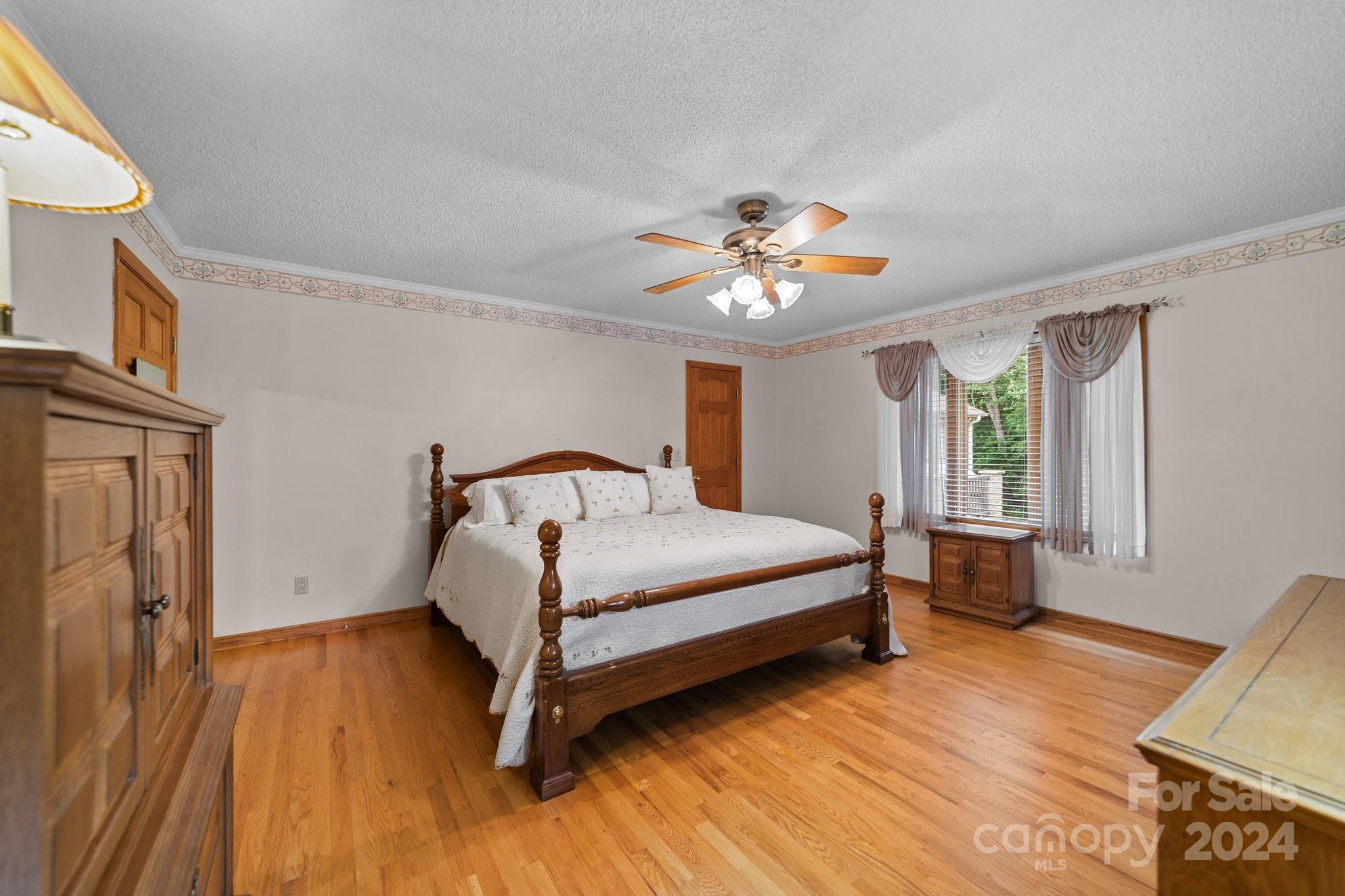 1808 Thompson Drive Concord, NC 28025 - Photo 23 of 48 a bedroom with a bed and a chandelier