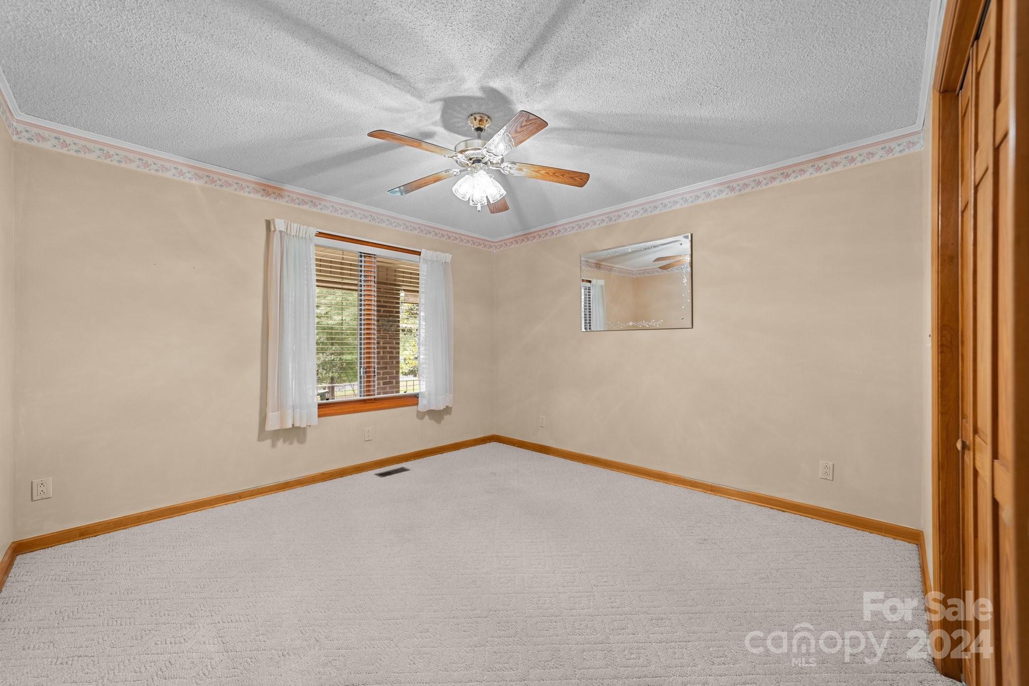 1808 Thompson Drive Concord, NC 28025 - Photo 29 of 48 an empty room with windows and fan