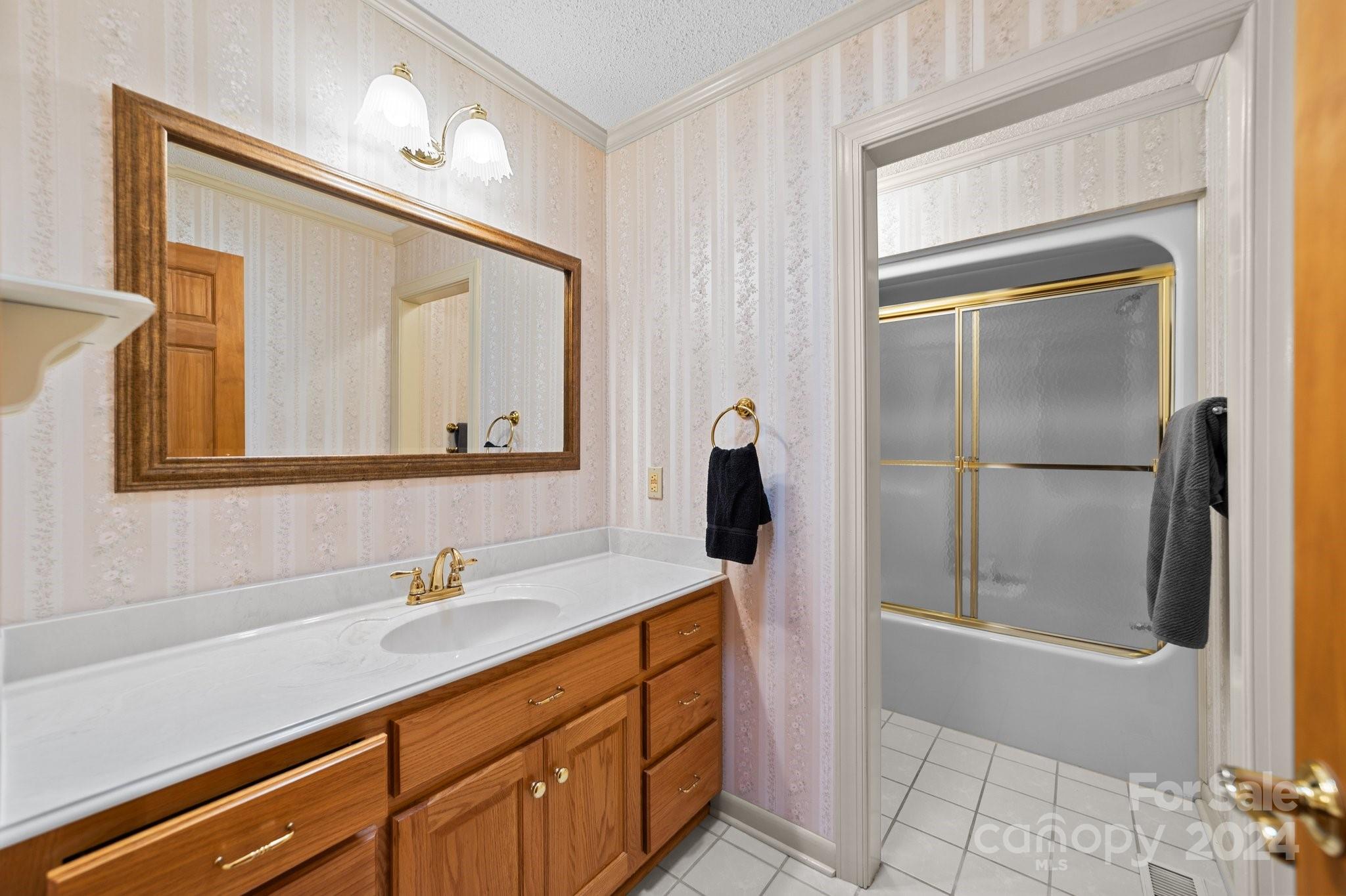 1808 Thompson Drive Concord, NC 28025 - Photo 32 of 48 a bathroom with a sink a mirror and a shower