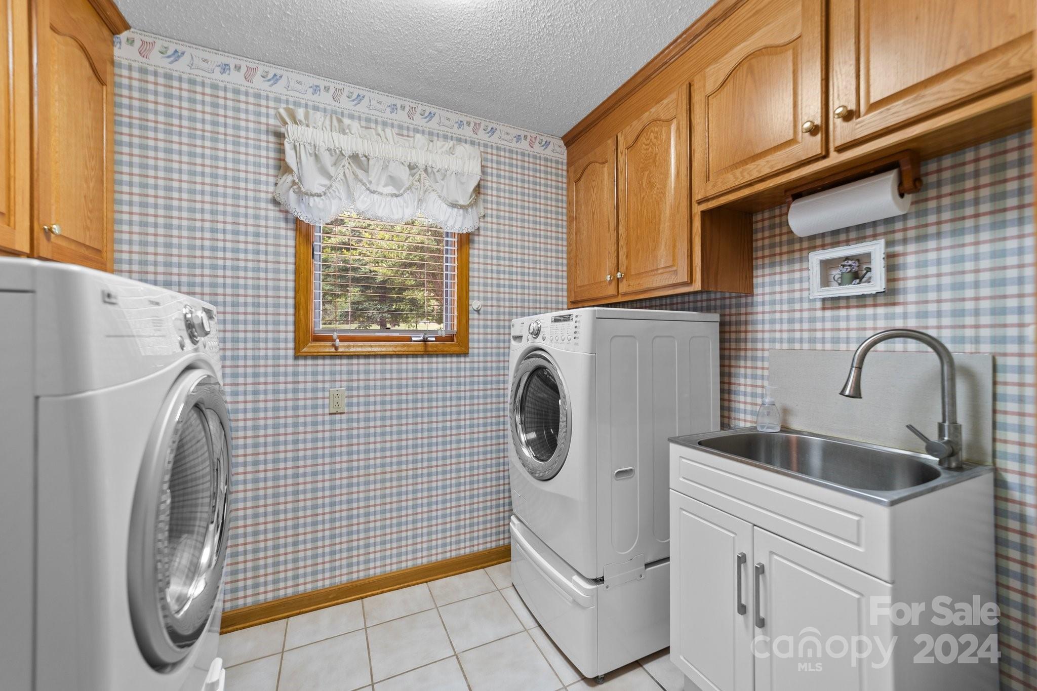 1808 Thompson Drive Concord, NC 28025 - Photo 47 of 48 a bathroom with a sink a washer and dryer