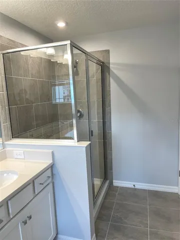 a bathroom with a shower and a sink