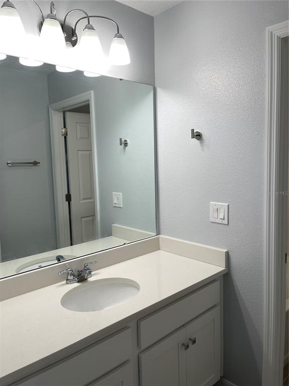 8937 Matriarca Alley Windermere, FL 34786 - Photo 15 of 17 a bathroom with a sink and a mirror
